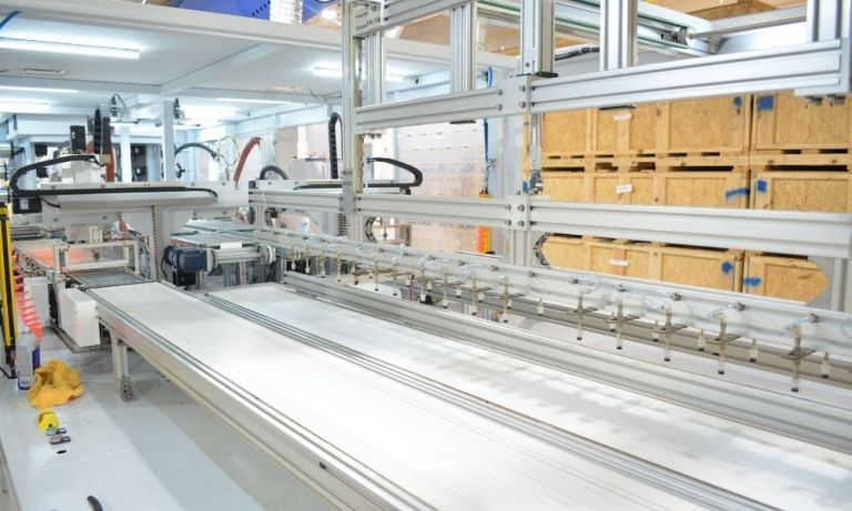 Long conveyor track and assembly system in a clean factory room.