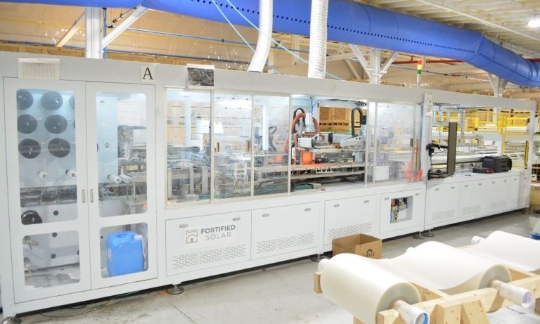 Large "Fortified Solar" automated machinery line in a factory.